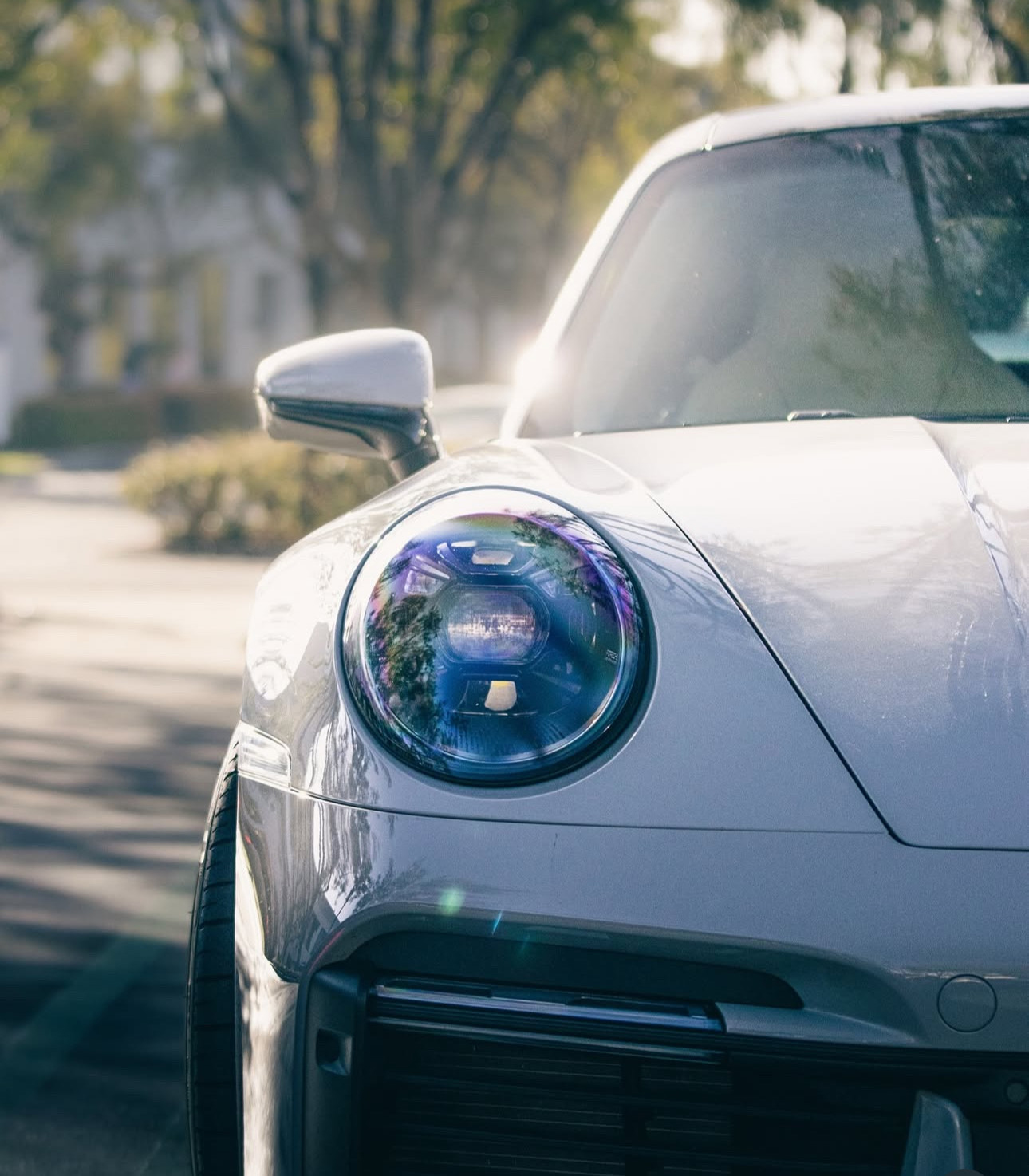 Close-up of a white Porsche 911 headlight